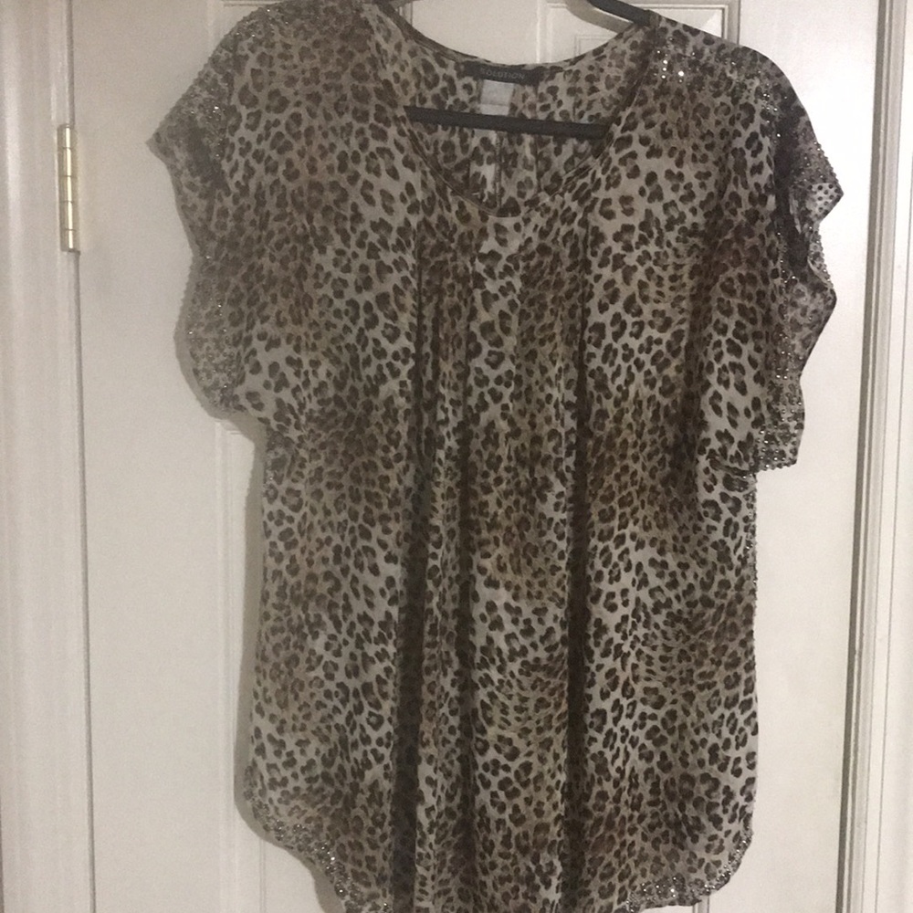 Light weight animal print rayon woman’s blouse with stud embellished trim.